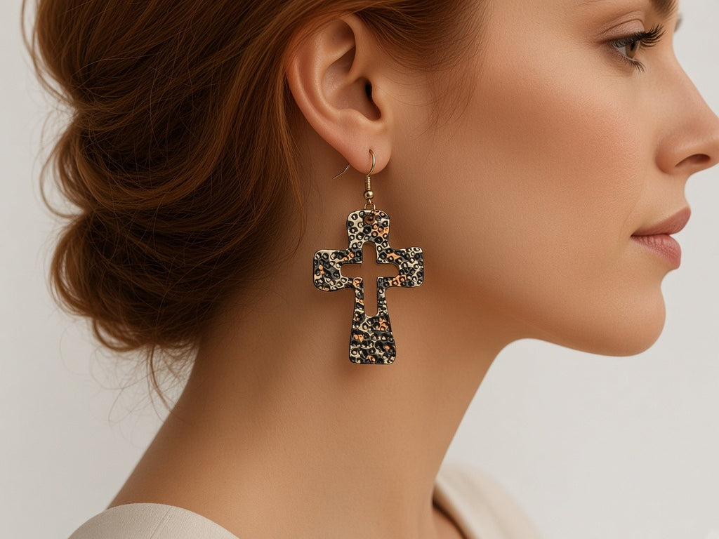 Earrings - leopard print cross worn by a model