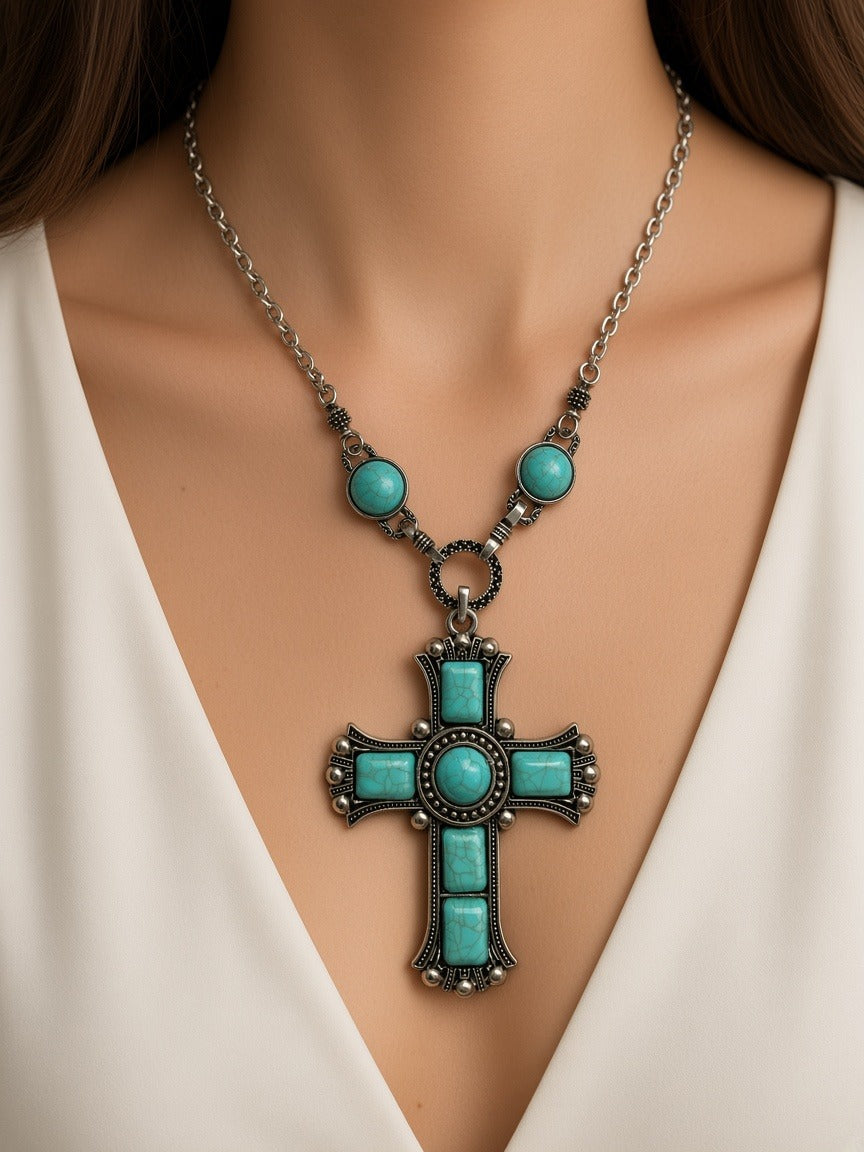 Necklace - large turquoise cross pendant worn by a model